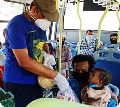 Volunteers distributing food to people on the street during a hunger relief drive 